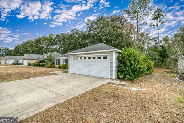 a view of a house with a yard and tree