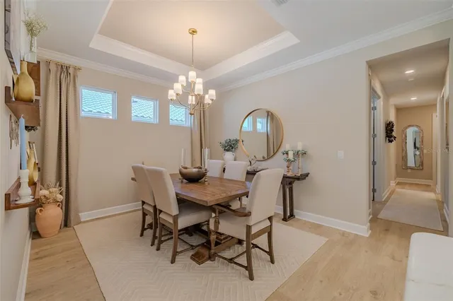 a view of a dining room with furniture and chandelier