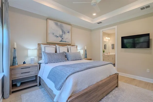 a bedroom with a bed and a flat screen tv