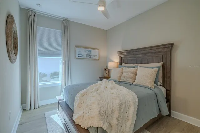 a large bed sitting in a bedroom next to a window