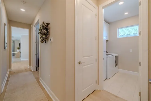 a view of a hallway with a livingroom and a bathroom