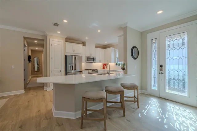 a kitchen with a sink cabinets and wooden floor