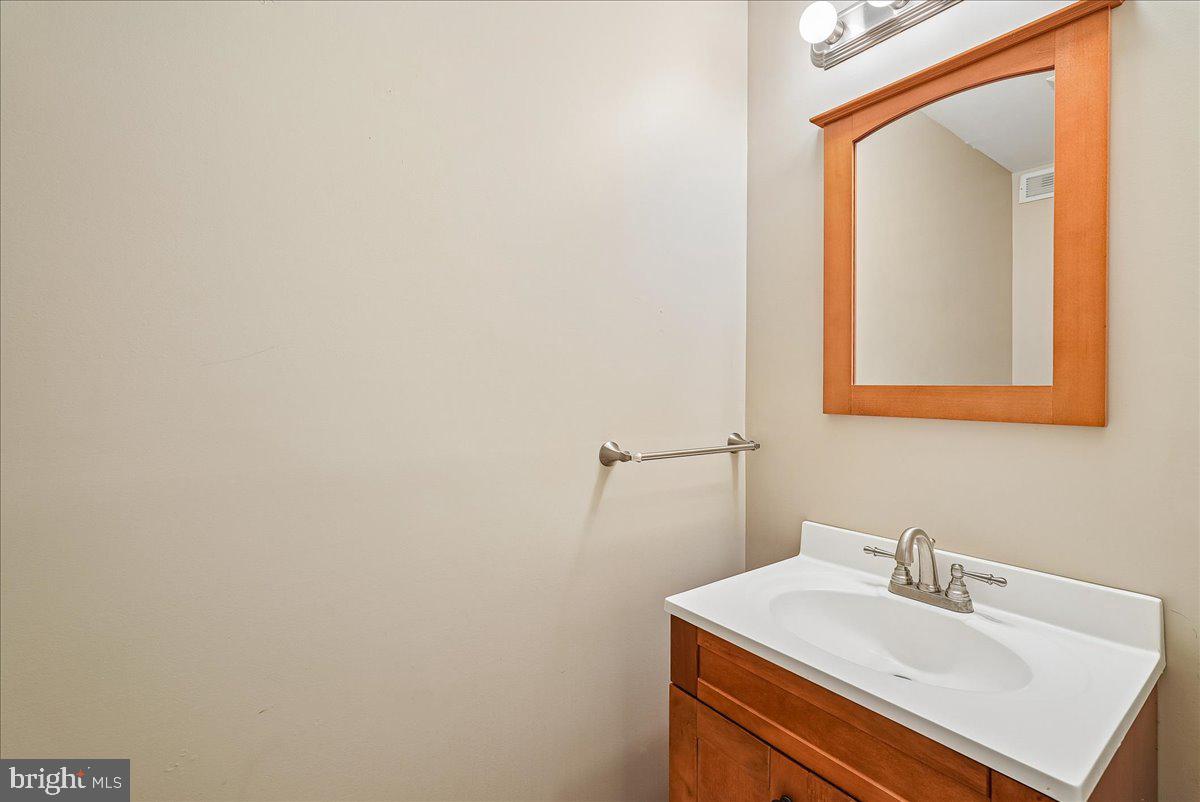 2331 Middle Creek Lane Reston, VA 20191 - Photo 45 of 78 a bathroom with a sink and a mirror