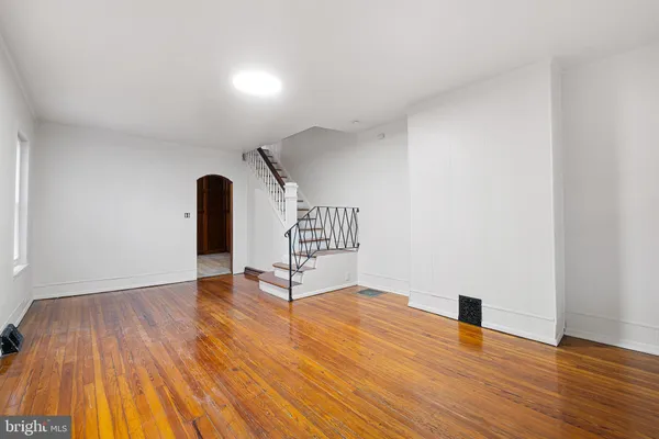 a view of an empty room and wooden floor