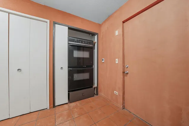 a backyard of a house with barbeque oven and outdoor seating