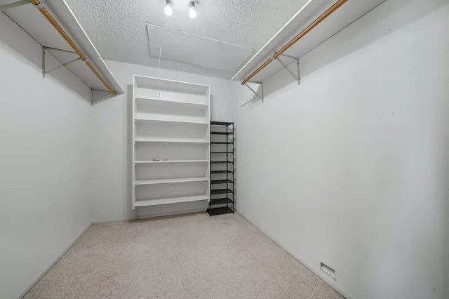 a living room with stainless steel appliances kitchen island granite countertop furniture and a flat screen tv