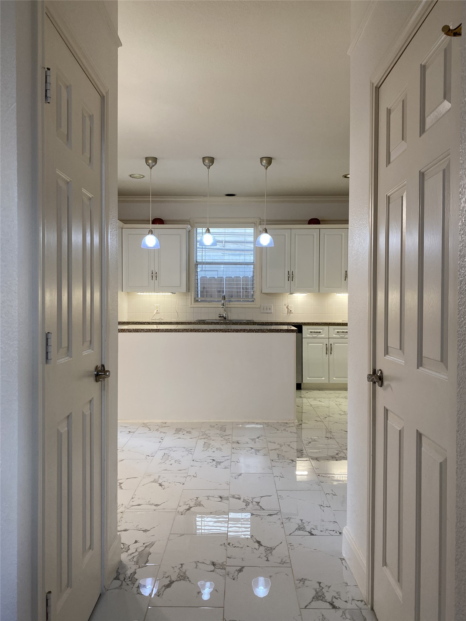 2604 Hopkins Street, Unit 1/2 Houston, TX 77006 - Photo 11 of 26 From the entry into the kitchen from the living room, behind the door on the left is a walk-in pantry, behind the door on the right is a convenient 1/2 bath.