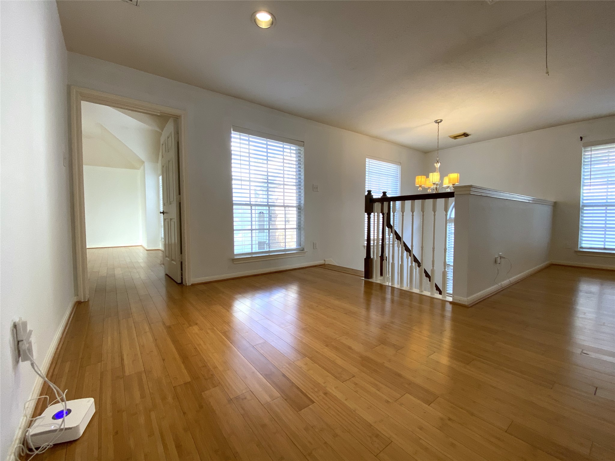 2604 Hopkins Street, Unit 1/2 Houston, TX 77006 - Photo 20 of 26 The view from the second secondary bedroom into the flex room, and beyond into the primary bedroom. Notice all the windows bringing in natural light.
