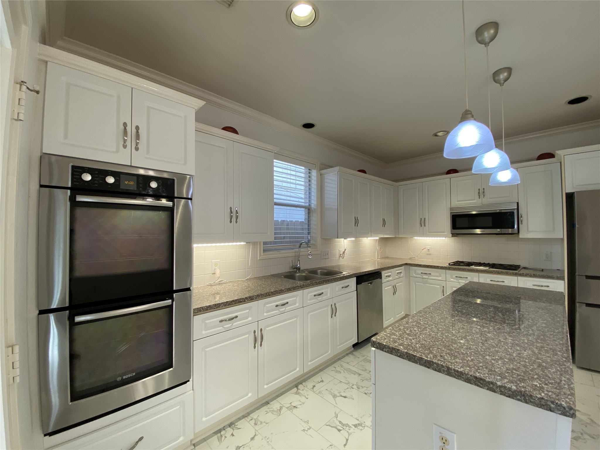 2604 Hopkins Street, Unit 1/2 Houston, TX 77006 - Photo 6 of 26 Stepping into the island kitchen from the dining room, with convection baking option, the double oven is Bosch brand.