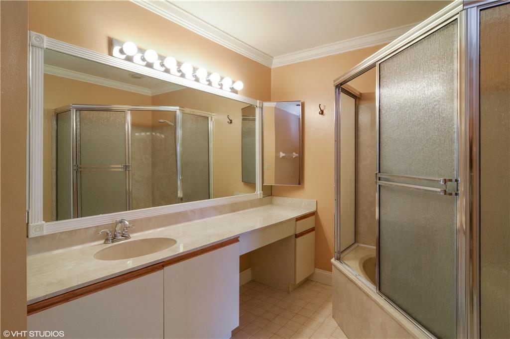 3410 Southeast Martinique Trace, Unit 202 Stuart, FL 34997 - Photo 11 of 15 a bathroom with a double vanity sink and a mirror