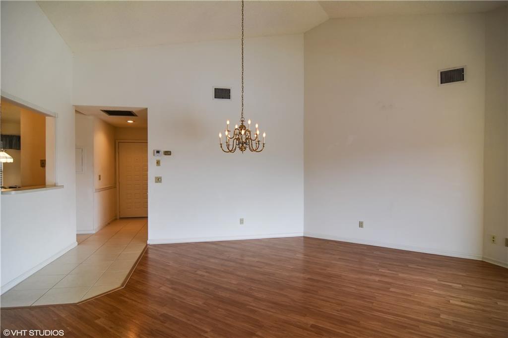 3410 Southeast Martinique Trace, Unit 202 Stuart, FL 34997 - Photo 6 of 15 a view of empty room with wooden floor