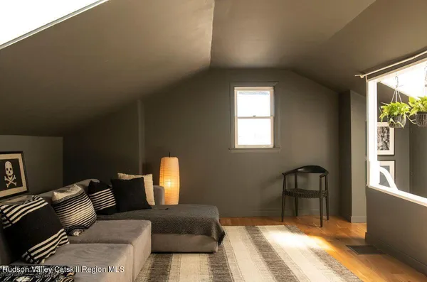 a bedroom with furniture and a window