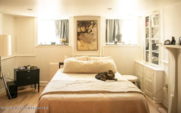 a bedroom with a bed and wooden floor