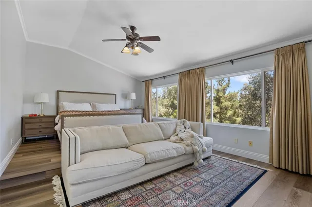 a view of a room with a large window and wooden floor