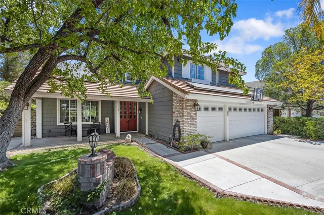 a living room with furniture and a table with wooden floor
