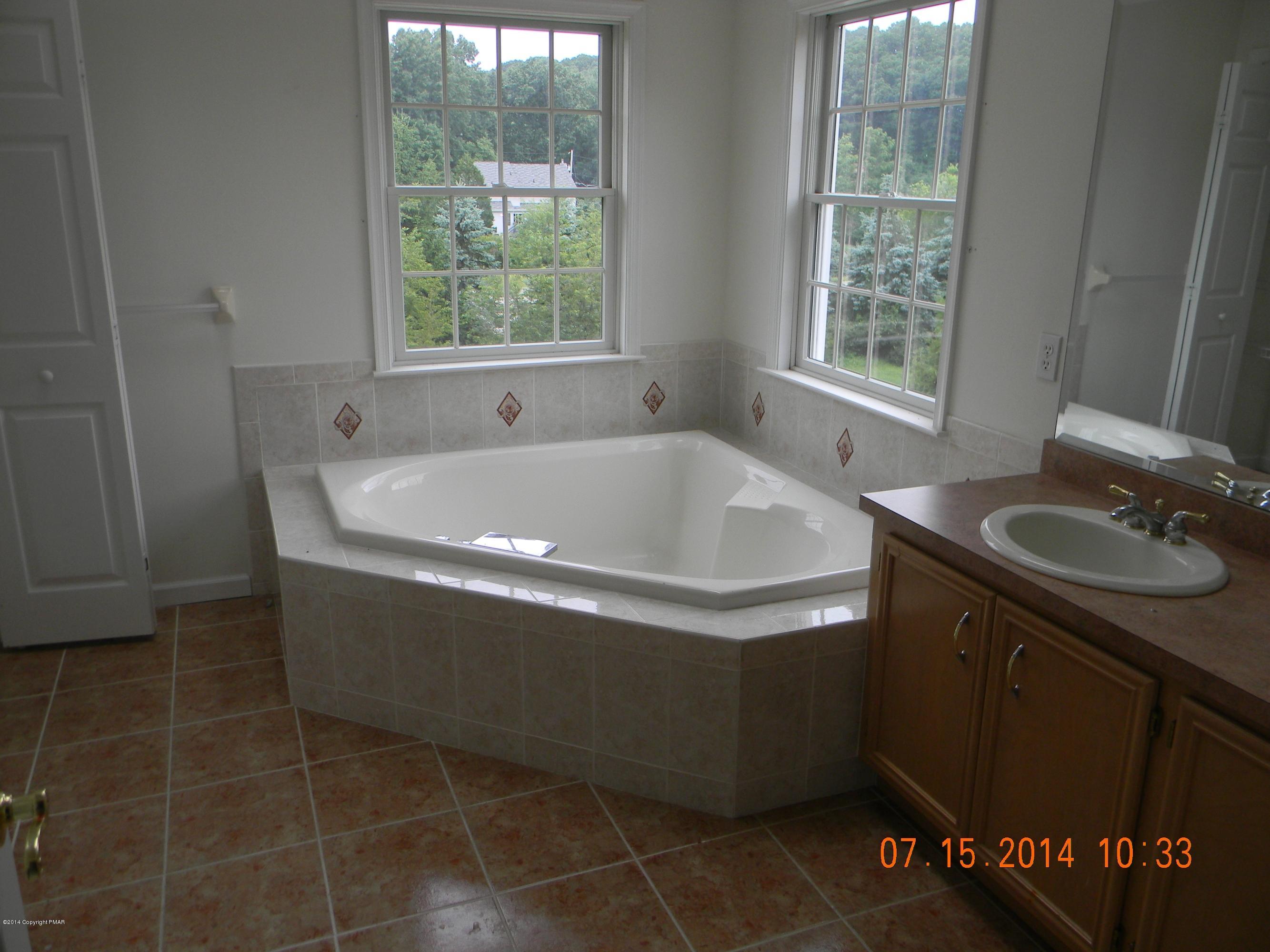 5513 Bridle Road Stroudsburg, PA 18360 - Photo 11 of 15 a bath tub sitting in a bathroom next to a window