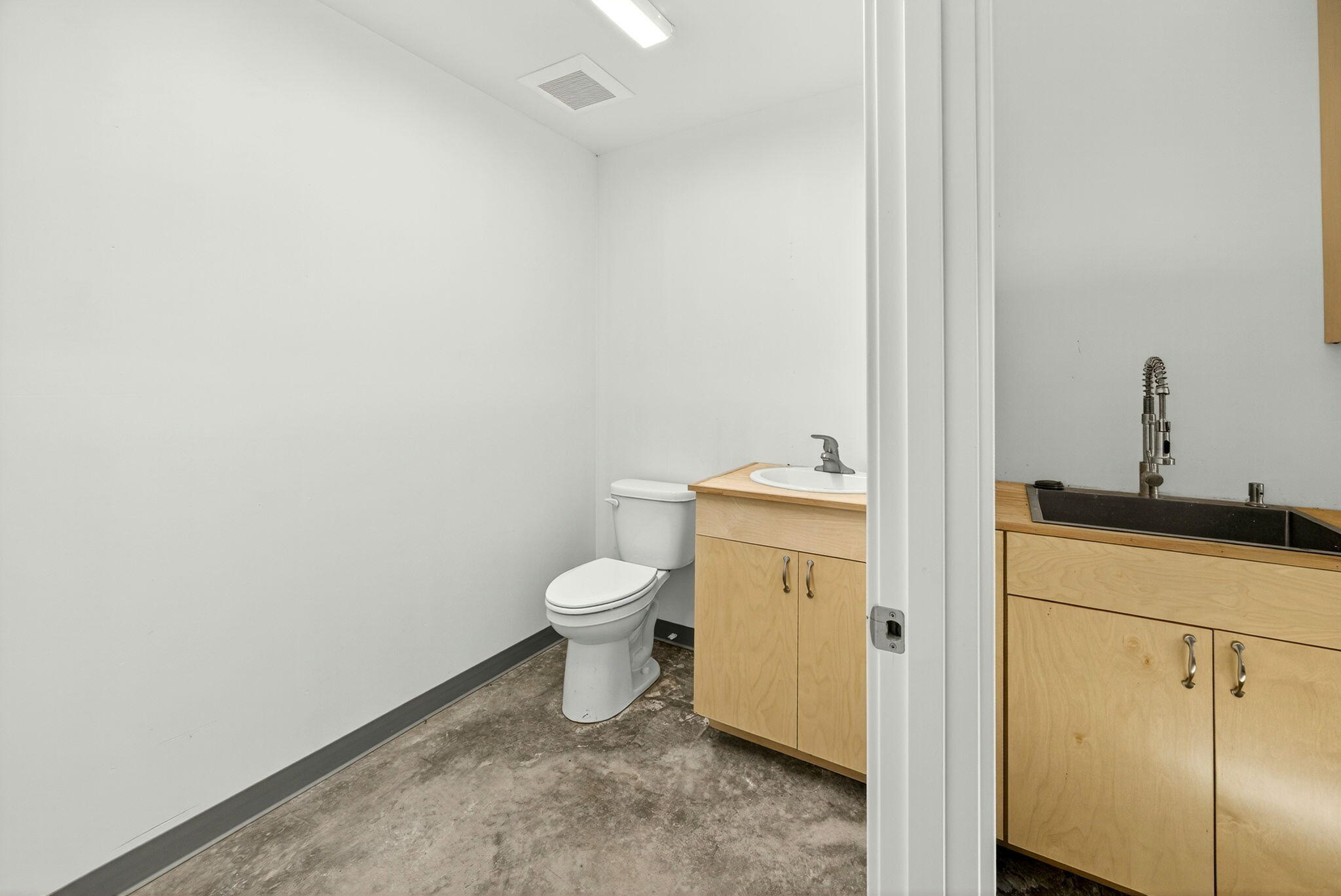 1176 Hamilton Road Jacksonville, OR 97530 - Photo 36 of 125 a white toilet sitting next to a bathroom sink