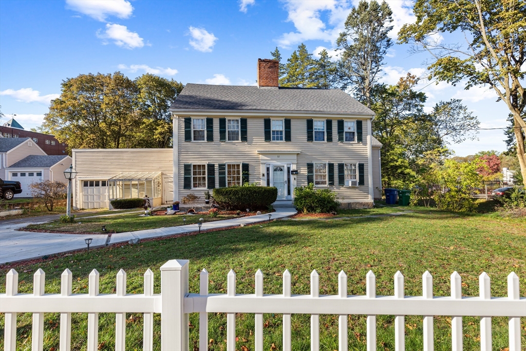 52 Salem Street Reading, MA 01867 - Photo 1 of 26 a front view of a house with a garden