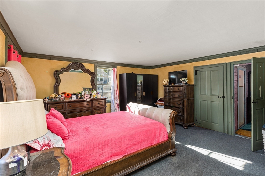 52 Salem Street Reading, MA 01867 - Photo 16 of 26 a bed room with a bed and a television