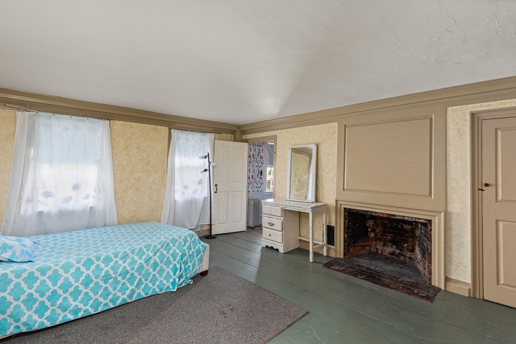 52 Salem Street Reading, MA 01867 - Photo 22 of 26 a living room with furniture and a fireplace