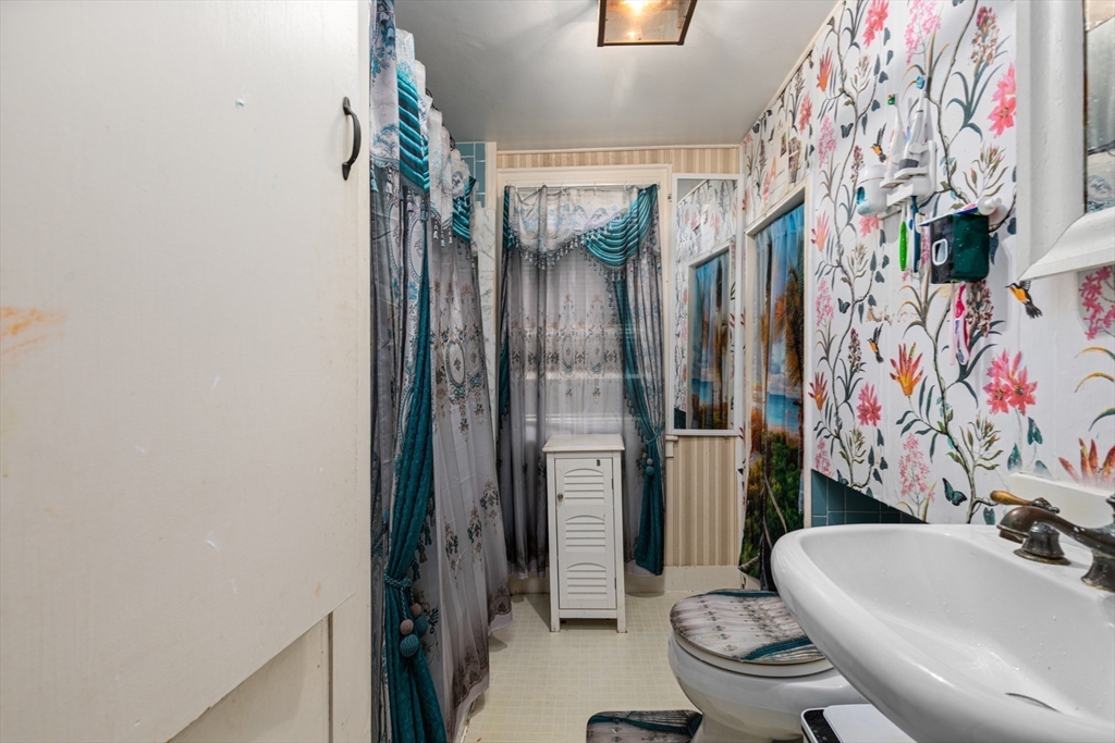 52 Salem Street Reading, MA 01867 - Photo 23 of 26 a bathroom with a sink toilet and shower curtain