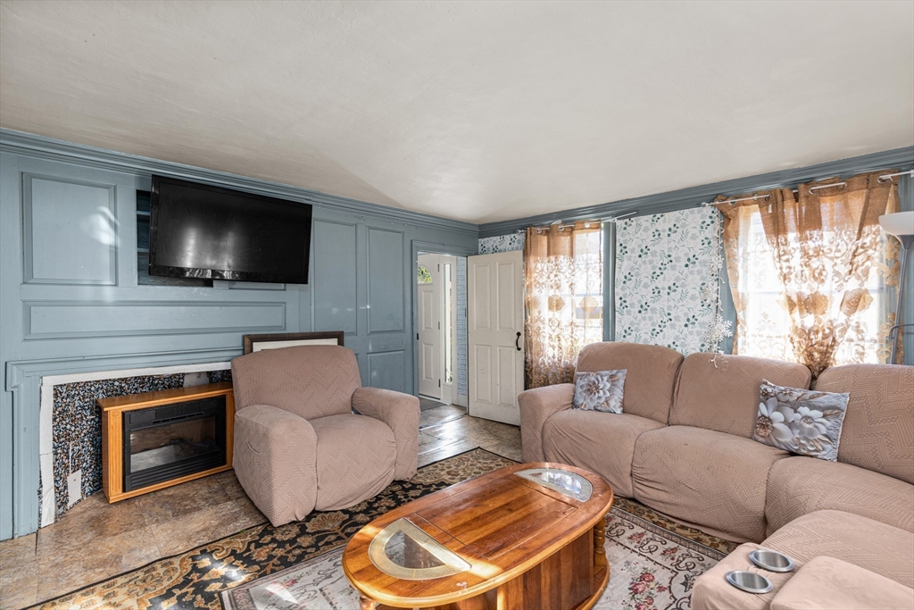 52 Salem Street Reading, MA 01867 - Photo 4 of 26 a living room with furniture and a flat screen tv