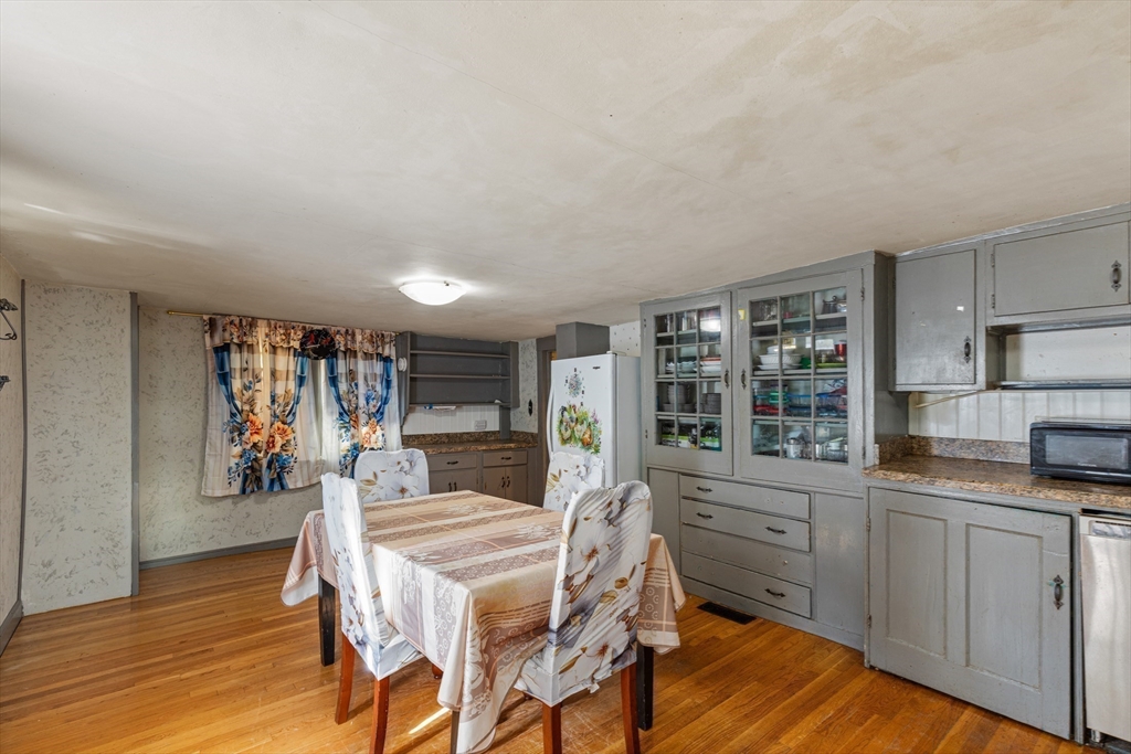 52 Salem Street Reading, MA 01867 - Photo 10 of 26 a kitchen with a table chairs refrigerator and cabinets