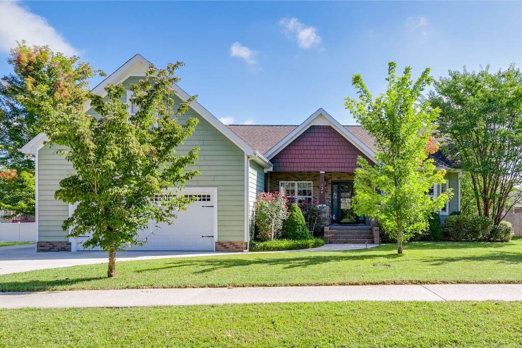 a house that has a tree in front of it