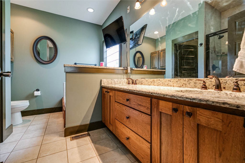 124 Riley Creek Road Tullahoma, TN 37388 - Photo 15 of 30 a spacious bathroom with a granite countertop sink a mirror and a toilet