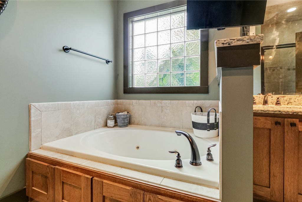 124 Riley Creek Road Tullahoma, TN 37388 - Photo 16 of 30 a bathroom with a bathtub and a window