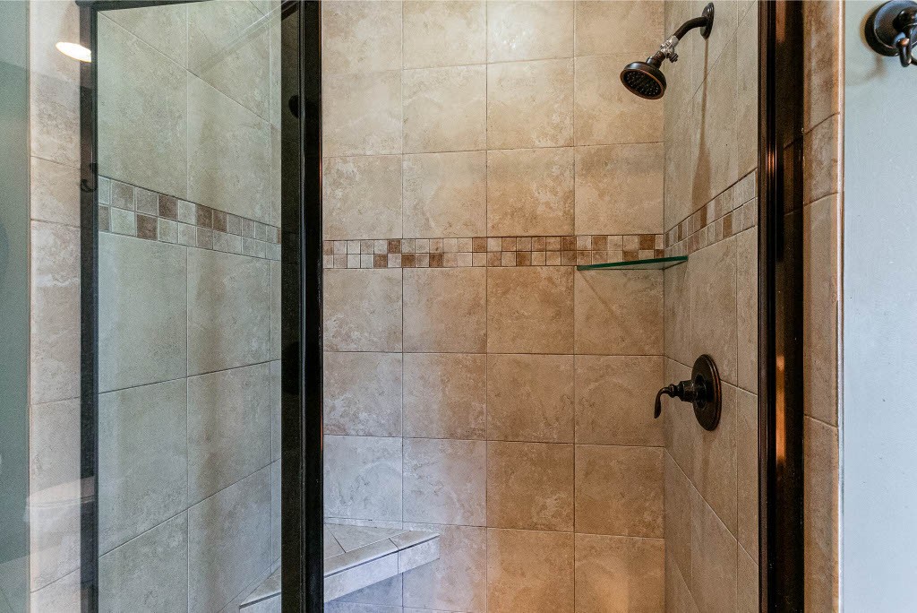 124 Riley Creek Road Tullahoma, TN 37388 - Photo 17 of 30 a bathroom with a glass shower door