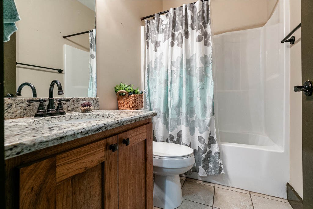 124 Riley Creek Road Tullahoma, TN 37388 - Photo 21 of 30 a bathroom with a granite countertop sink toilet and shower