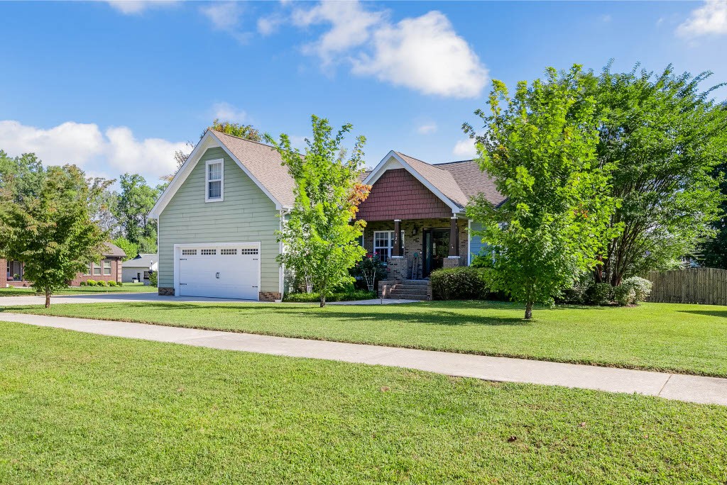 124 Riley Creek Road Tullahoma, TN 37388 - Photo 3 of 30 a front view of a house with a yard and garage