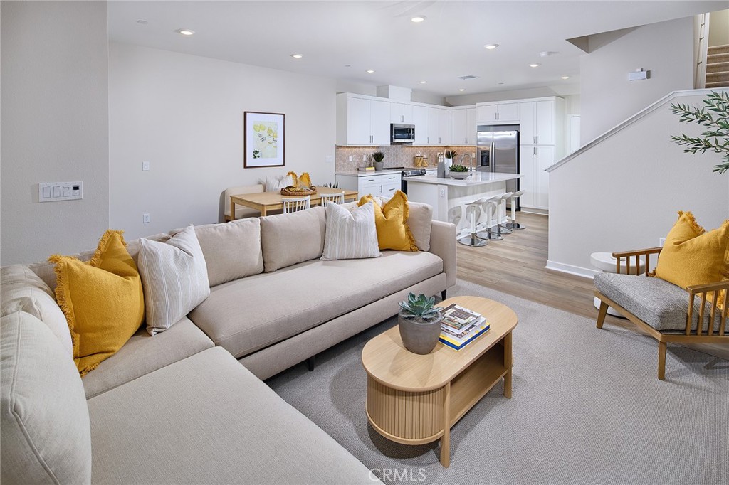 5911 Rockport Road Eastvale, CA 92880 - Photo 5 of 39 a living room with furniture and a view of kitchen