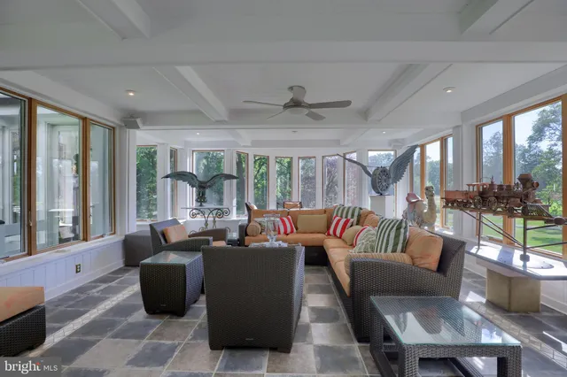 a view of a dining room with furniture a chandelier and wooden floor