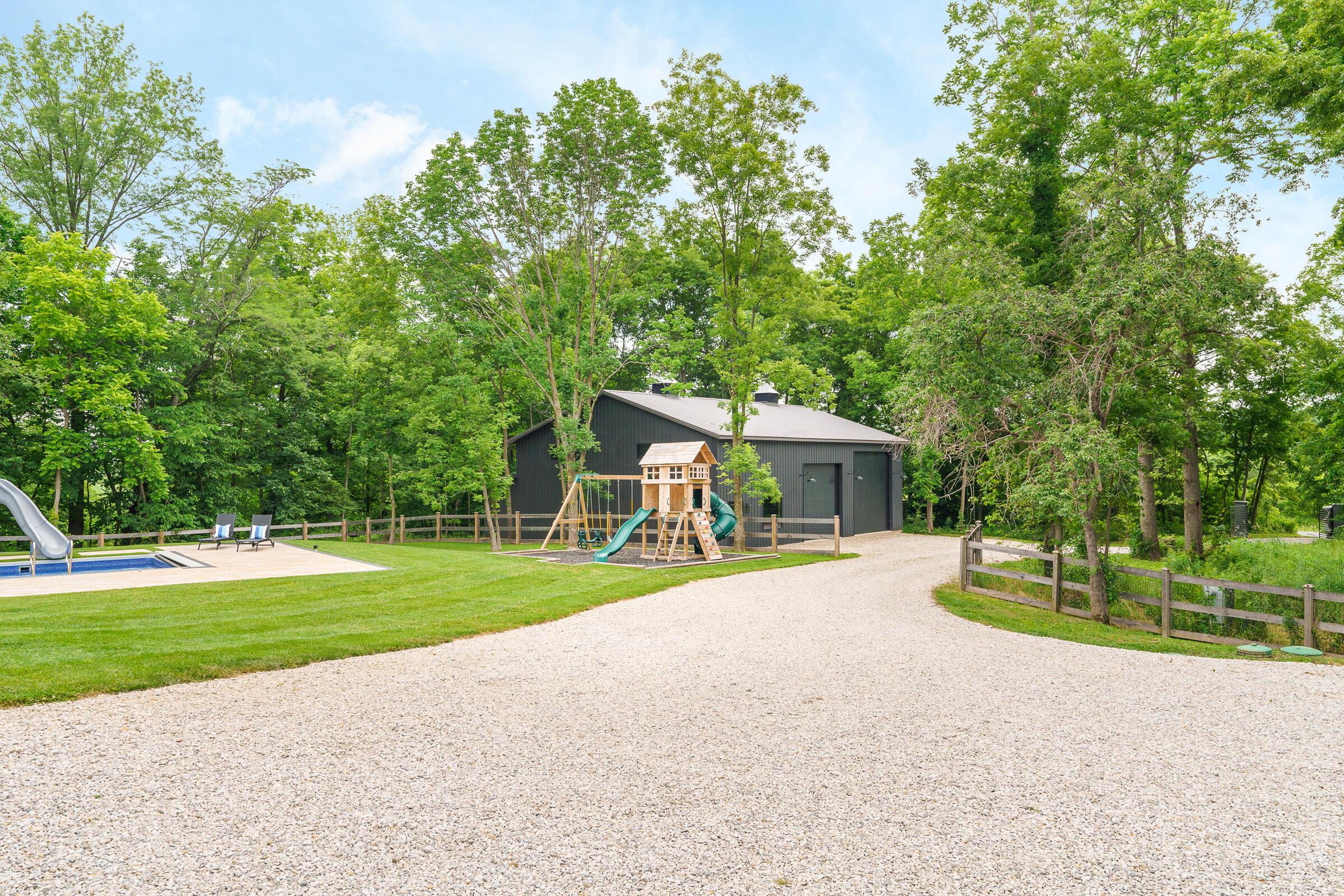 701 Ross Road Sunbury, OH 43074 - Photo 67 of 74 View from the porch to the pole barn, playground and pool