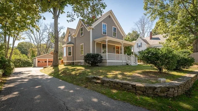 a front view of house with yard and trees around