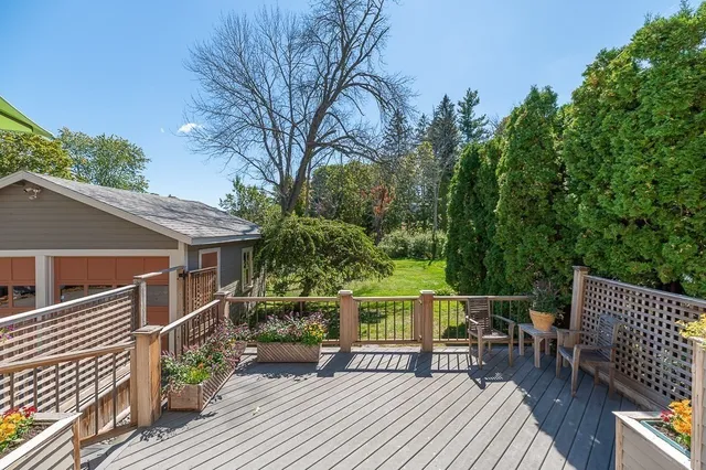 a view of a roof deck with wooden floor and fence
