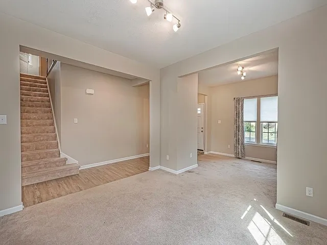 an empty room with windows and entrance