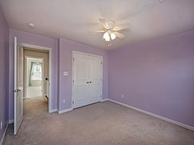 a view of an empty room with a fan