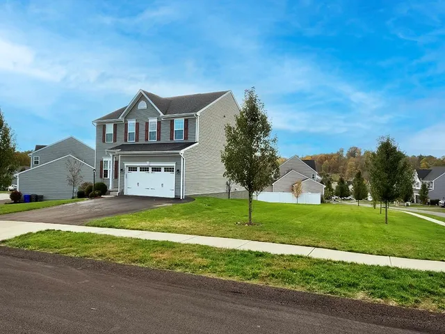 a front view of a house with a yard