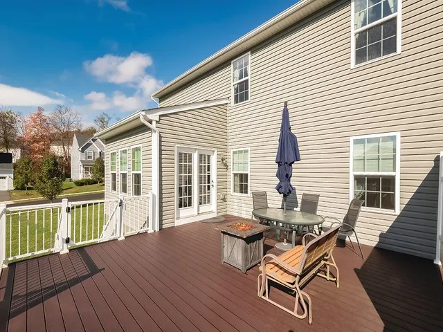 a view of a house with wooden deck and a floor
