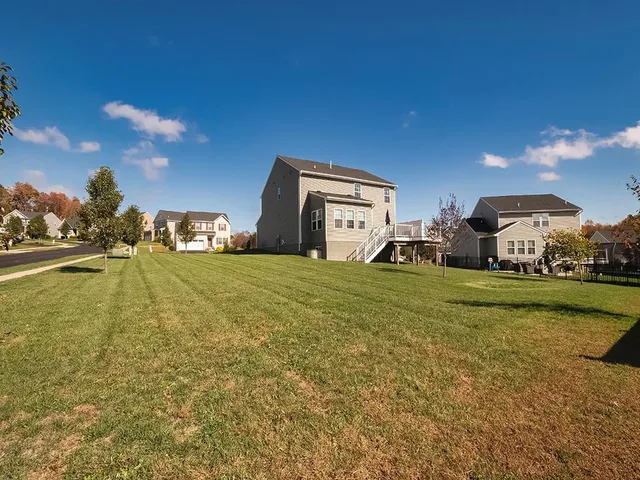 a house view with swimming pool in front of it