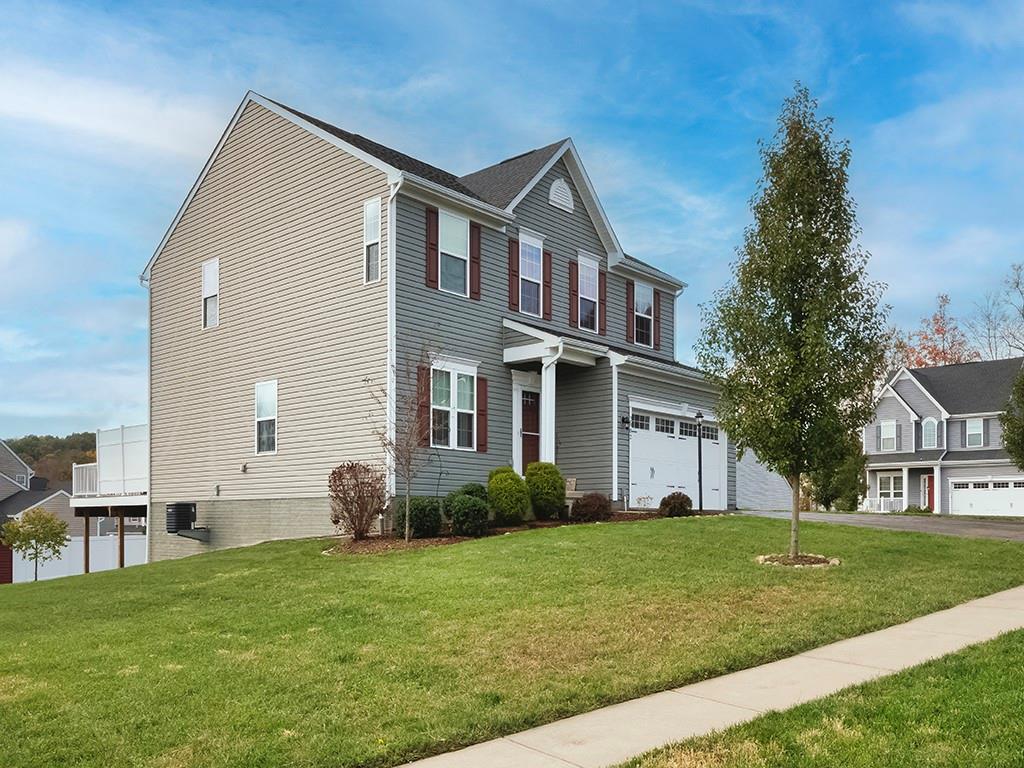2002 Bald Eagle Court Valencia, PA 16059 - Photo 4 of 42 a front view of a house with a garden