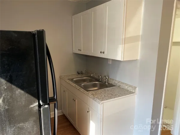 a kitchen with stainless steel appliances granite countertop a refrigerator and a stove
