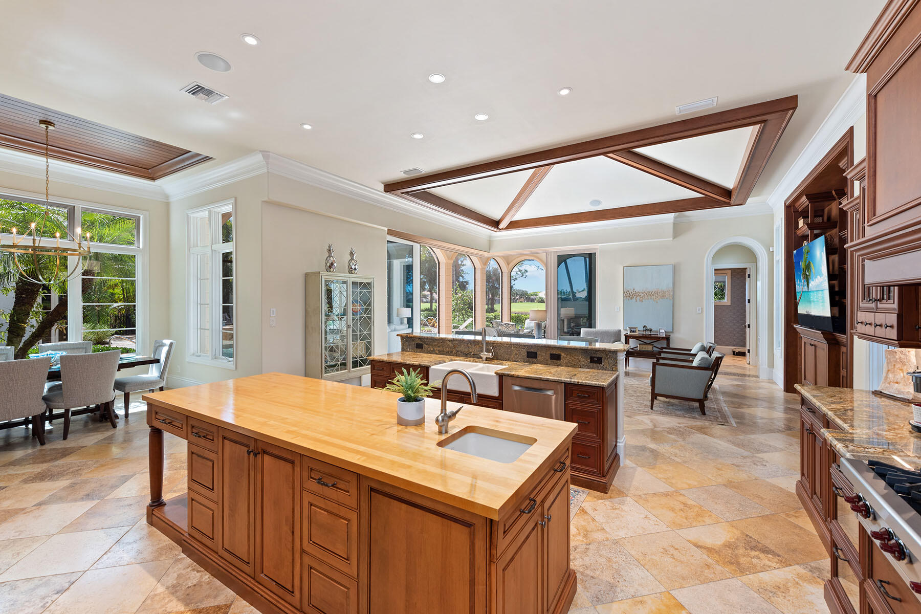 3855 Isla Del Sol Way Naples, FL 34114 - Photo 12 of 50 a large kitchen with kitchen island a sink a counter top space and living room view