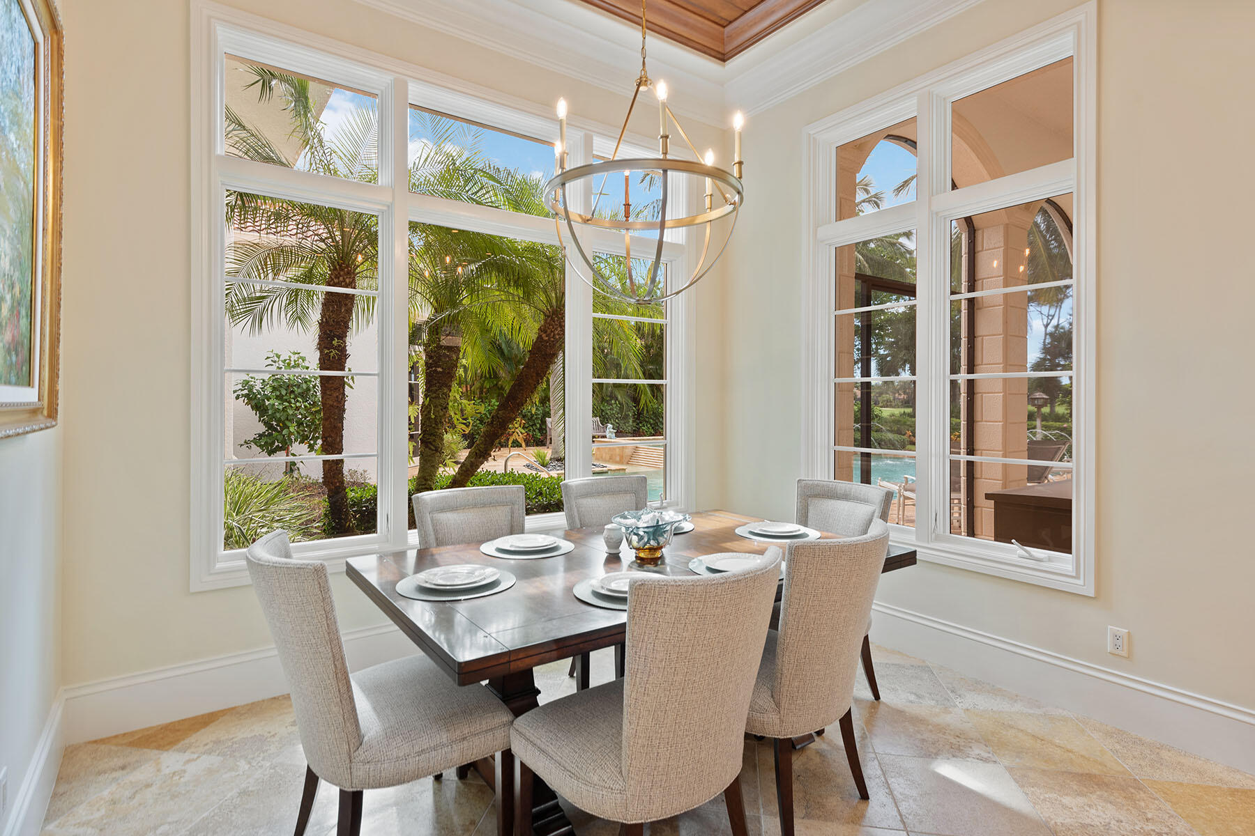 3855 Isla Del Sol Way Naples, FL 34114 - Photo 14 of 50 a view of a dining room with furniture large windows and wooden floor