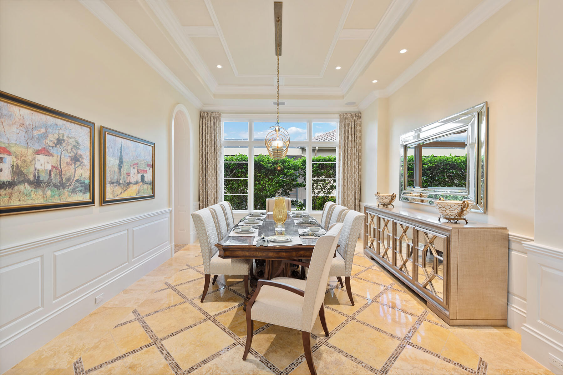 3855 Isla Del Sol Way Naples, FL 34114 - Photo 15 of 50 a dining room with furniture a flat screen tv and a chandelier