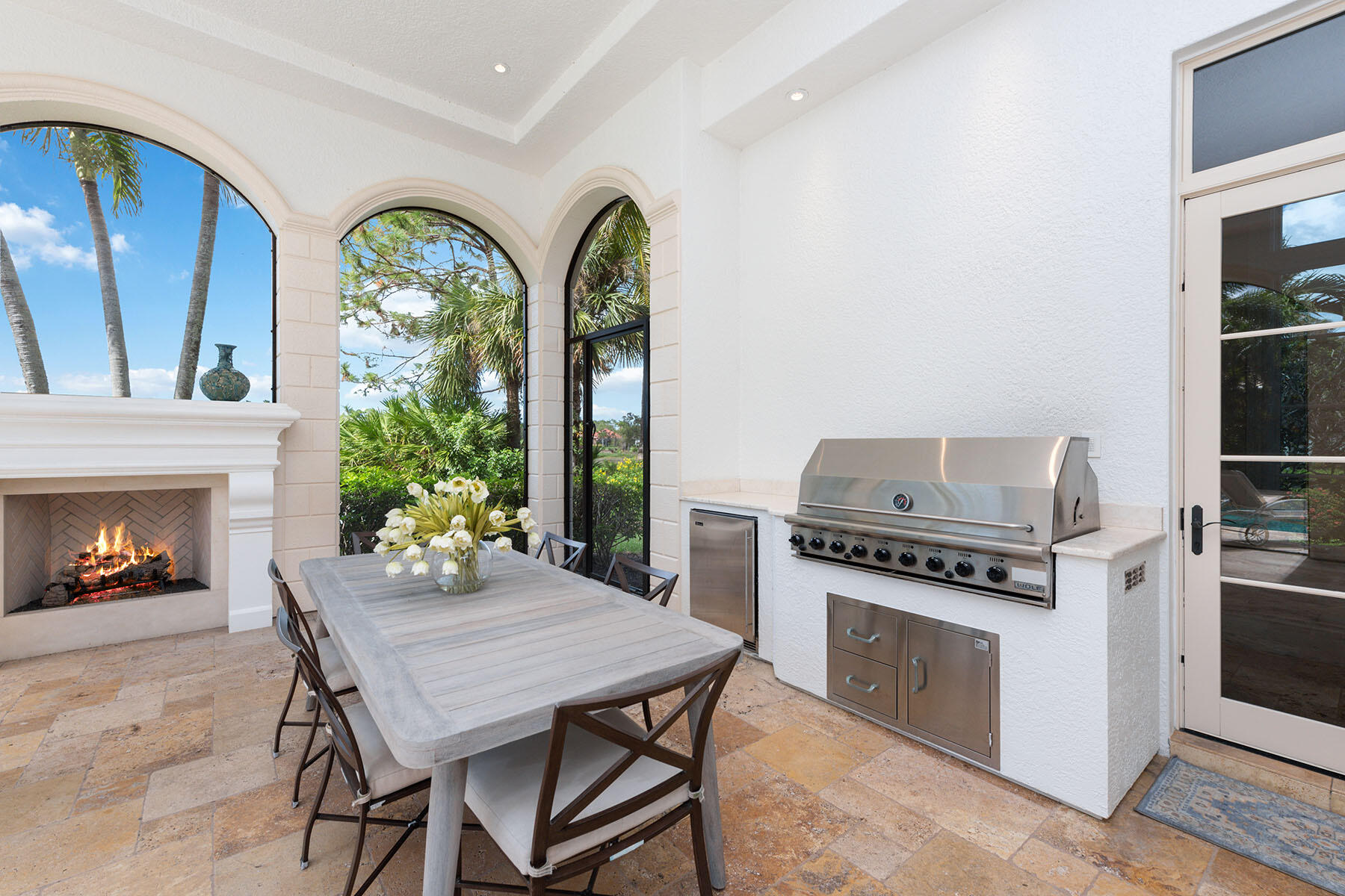 3855 Isla Del Sol Way Naples, FL 34114 - Photo 40 of 50 a kitchen with a stove and a fireplace