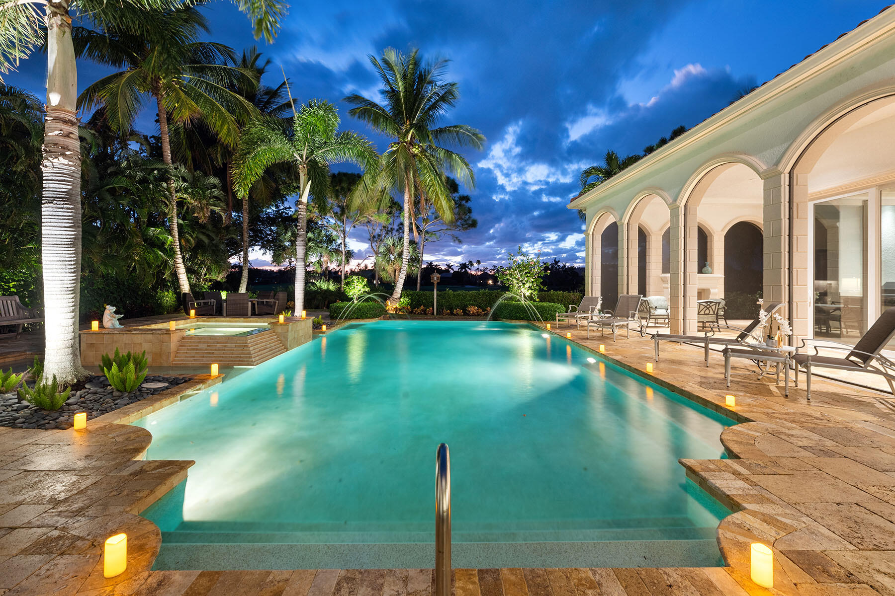 3855 Isla Del Sol Way Naples, FL 34114 - Photo 41 of 50 a view of a swimming pool with a lawn chairs and palm trees